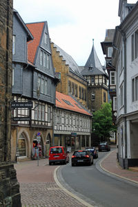 Cars on street by buildings in city