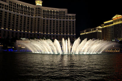 View of fountain in city at night