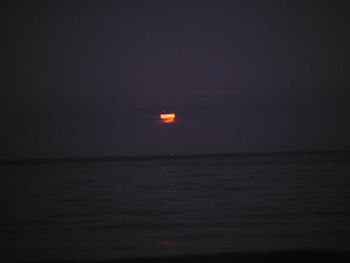 Scenic view of sea against clear sky at night