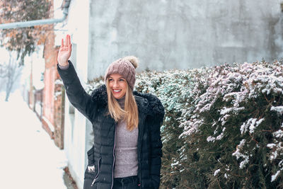 Young woman standing in snow