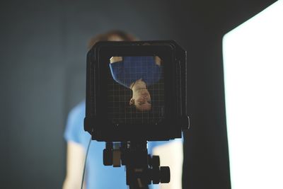 Upside down image of man on large format camera