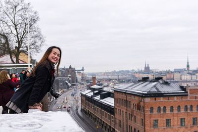 Woman standing at observation point against sky during winter