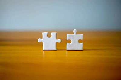 Close-up of jigsaw pieces on table