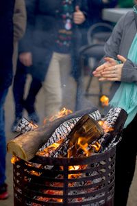 Cropped image of woman by fire pit