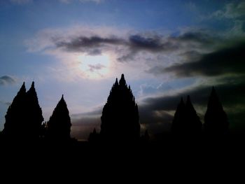 Silhouette of temple building against sky during sunset