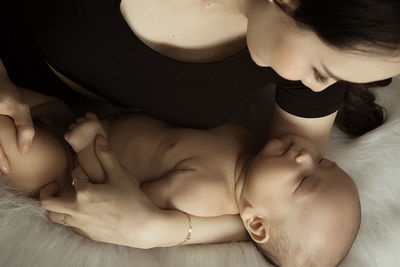 Close-up of baby girl on bed