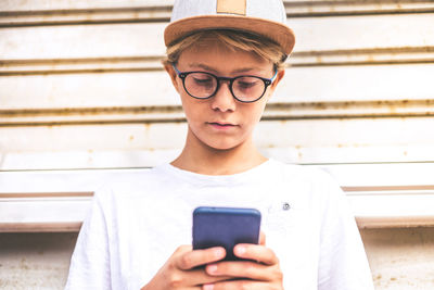 Portrait of teenage boy using mobile phone