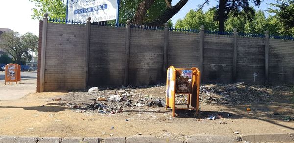 Abandoned garbage by building in city