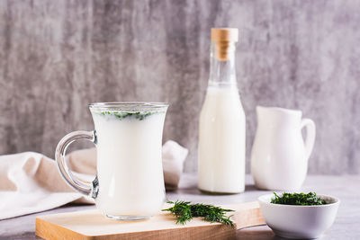 Ayran homemade yogurt drink with dill in a glass on the table