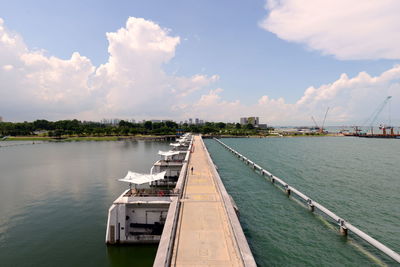 Pier over river against sky