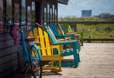 Empty chairs and tables against building