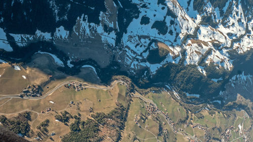 High angle view of land and sea against mountain