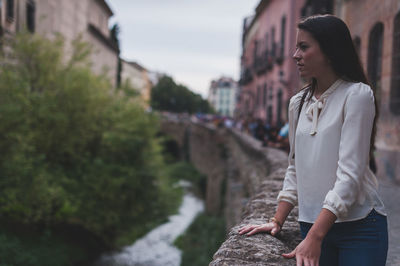 Woman standing by railing