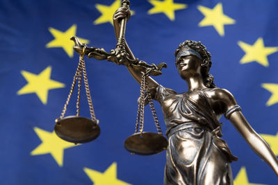 Lady justice statue against european union flag