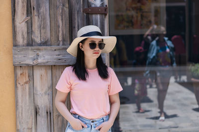 Young woman wearing sunglasses standing outdoors