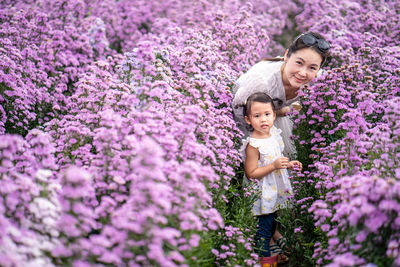Woman standing on purple flowering plants