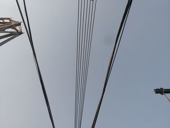 Low angle view of electricity pylon against clear sky