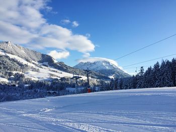 Snow covered landscape against sky