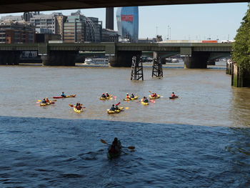 Group of people on bridge over river