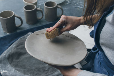 Midsection of woman working in workshop