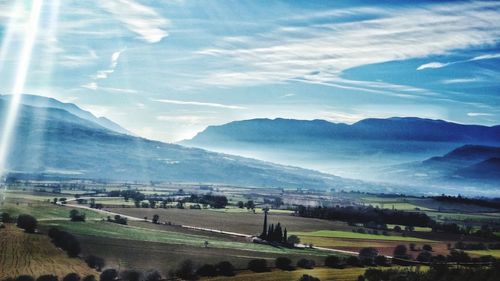 Scenic view of agricultural field and mountains against sky