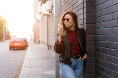 Young woman standing on street in city