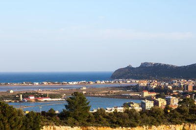 High angle view of city by sea against sky