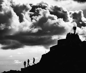 Silhouette of eiffel tower against cloudy sky