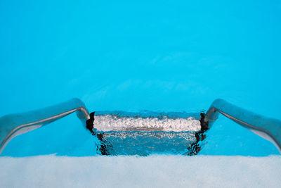 Directly above view of swimming pool ladder