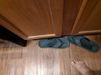 Low section of man on wooden floor