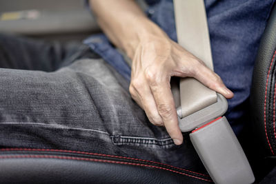 Midsection of man sitting in bus