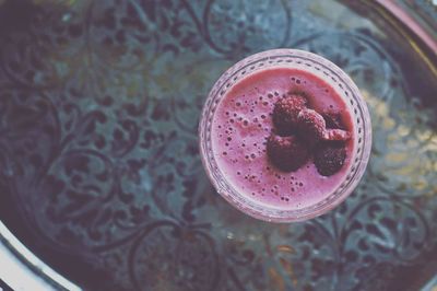 High angle view of raspberry smoothie on table