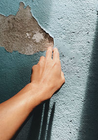 Close-up of hand on wall