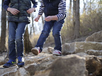 Low section of people walking on rock