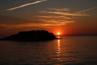 Scenic view of sea against romantic sky at sunset