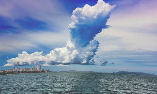 Panoramic view of sea and buildings against sky