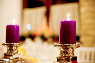 Close-up of illuminated candles on table