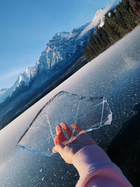 Cropped hand holding ice