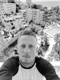 Portrait of man with city in background