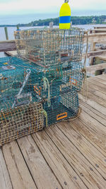 Close-up of deck chairs on beach against sky