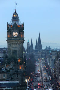 Illuminated buildings in city at dusk