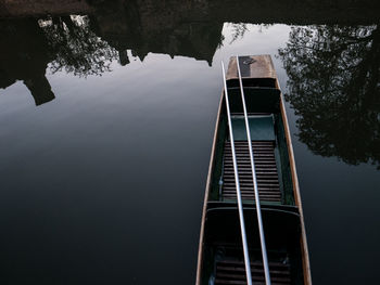 Low angle view of ladder by lake against sky