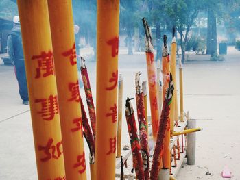 Close-up of paintbrushes on beach by building