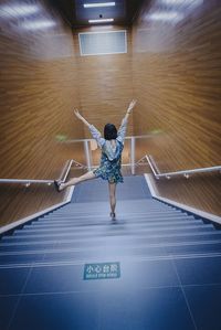 Full length of woman standing by railing