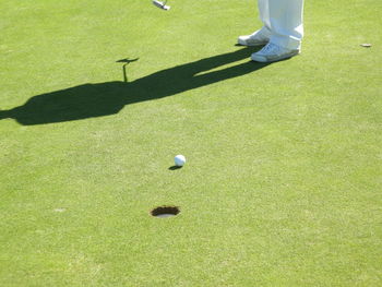 Low section of man standing on golf course