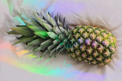High angle view of pineapple on white fabric