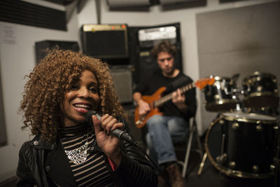 Close-up of woman singing on microphone