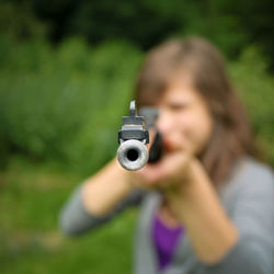 Portrait of woman holding camera