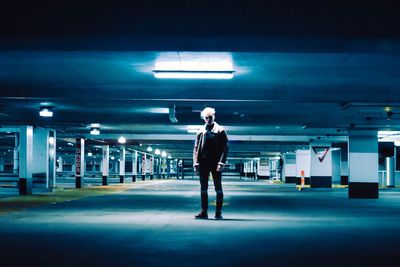 Full length of woman standing in parking lot