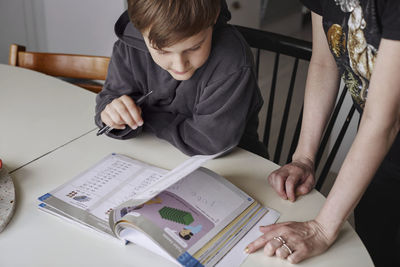 Mother helping son with homework